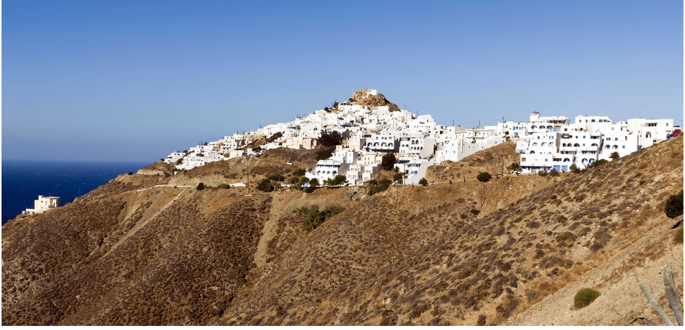 the hilltops of Anafi with white houses on