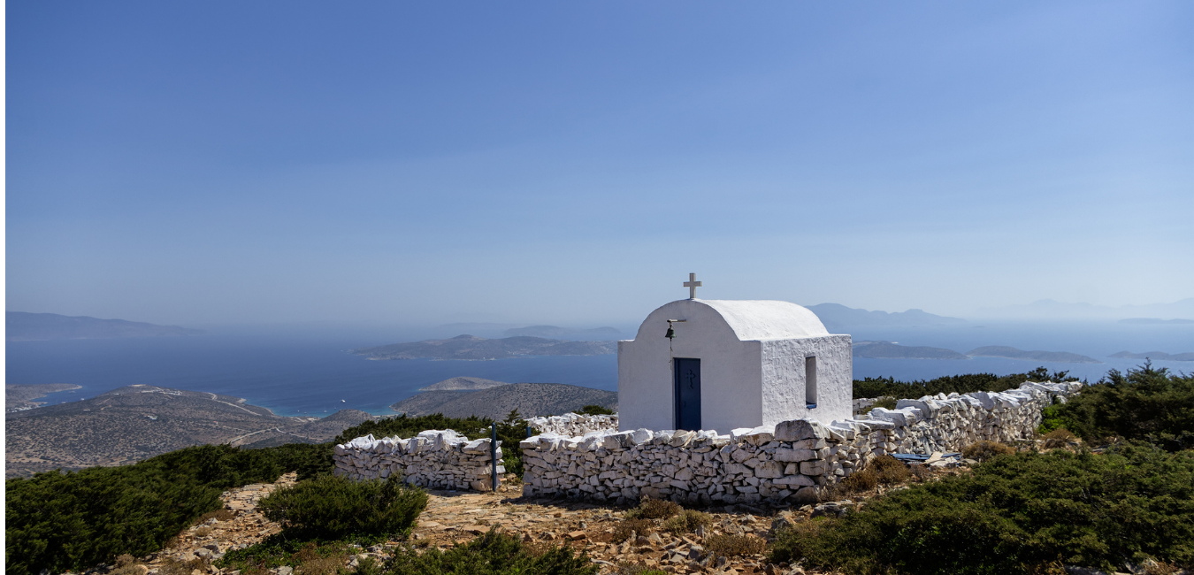 A small whitewashed chapel standing alone on hillside on Iraklia