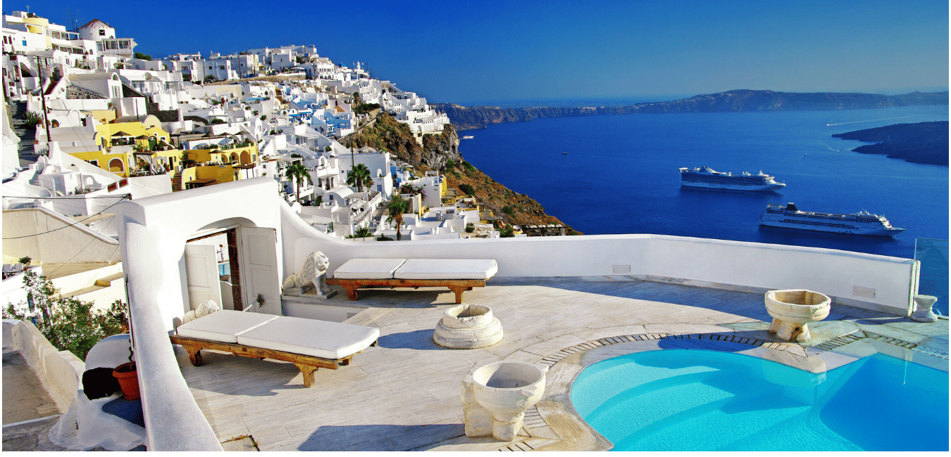 A Stepped hill covered with whitewashed houses overlooking the sea