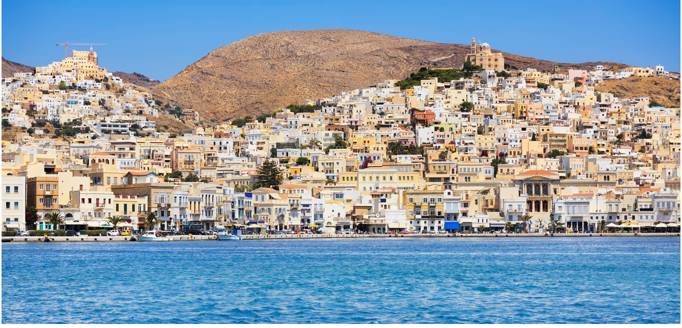 A photo looking from the sea at the Syros coastline
